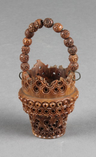 A pierced and carved walnut thimble in the form of a pail 2" 