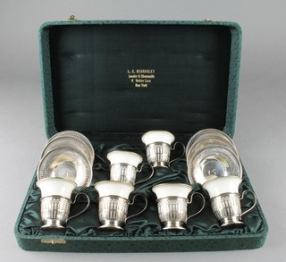 A cased set of 6 Continental porcelain coffee cans with sterling holders and pierced saucers 