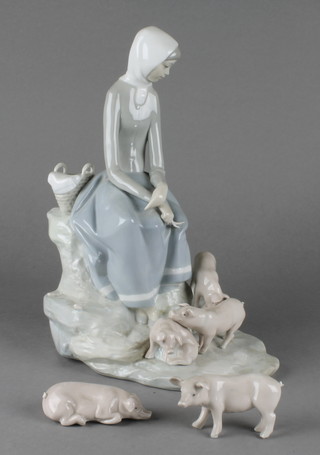 A Lladro group of a seated girl with 5 piglets 12" 