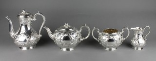 A fine mid Victorian repousse silver 4 piece tea and coffee set with floral and scroll decoration with vacant cartouches, Sheffield 1861, maker Martin Hall & Co, gross weight 2025 grams