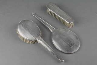 A 3 piece silver backed brush set with engine turned decoration Birmingham 1919/1920