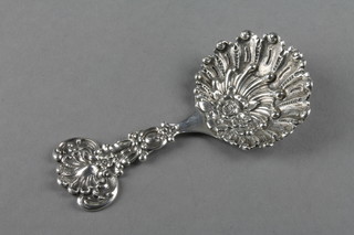 A Tiffany & Co Sterling silver repousse caddy spoon with shell handle and floral and shell bowl 4 1/2" 36 grams