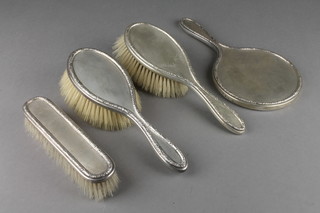 A silver 4 piece brush set with engine turned decoration, London 1950 
