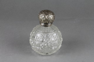 A cut glass toilet bottle with repousse silver lid 4" 