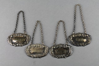 A set of 4 silver plated repousse spirit labels