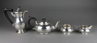 A silver 4 piece tea and coffee set of plain form with ebony mounts Birmingham 1930/34, gross 1000 grams