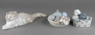 3 Nao figures, a reclining cat 11", 2 puppies in a box 4" and a puppy in a basket 5"  