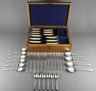 A Victorian canteen of Old English silver cutlery for 6, comprising 6 dinner forks, 6 dessert forks, 6 dessert spoons, 6 serving spoons and 6 teaspoons, London 1894 and 1895, 1464 grams 