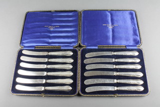 2 cased sets of silver handled butter knives