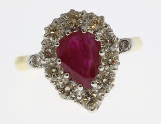 An 18ct yellow gold ruby and diamond pear shaped cluster ring, the ruby approx 1.8ct surrounded by 10 brilliant cut diamonds 1.1ct, size O