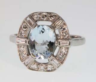 An 18ct gold aquamarine and diamond open dress ring, the centre stone approx. 1.3ct surrounded by 0.45 of diamonds, size P