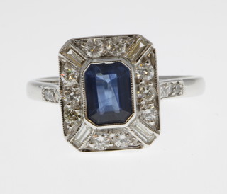 An 18ct white gold sapphire and diamond Art Deco style ring, the centre stone approx 2.2ct surrounded by 0.5ct of diamonds, size O 1/2