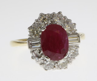An 18ct yellow gold ruby and diamond cluster ring, size N 1/2