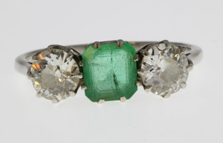 An 18ct white gold 3 stone ring, the centre emerald approx 1ct flanked by single diamonds each approx. 0.5ct, size Q