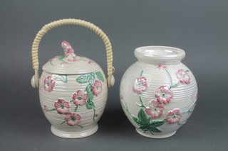 A Maling biscuit barrel with wicker handle 7", a ditto cylindrical vase 7"
