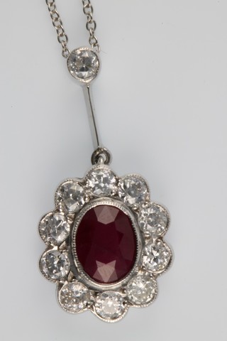 An 18ct white gold ruby and diamond cluster pendant, the centre stone approx 1.5ct surrounded by brilliant diamonds approx 1.0ct 