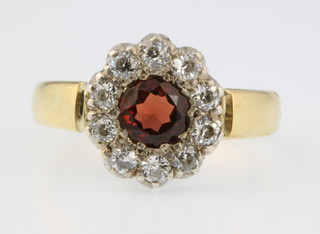 An 18ct gold ruby and diamond cluster ring, size P 1/2