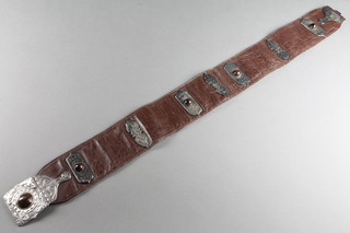 An Indian leather belt with white metal and "gem" set mounts