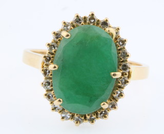 A yellow gold emerald and diamond cluster ring, size M 1/2