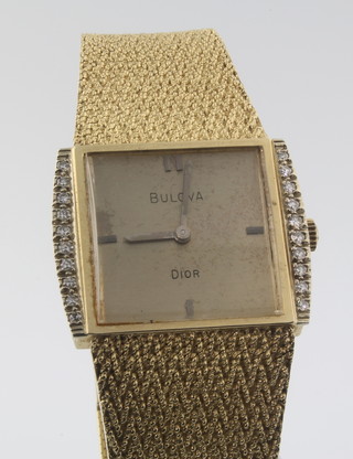A gentleman's 14ct gold Bulova Dior wristwatch, the bezel set with 20 brilliant cut diamonds, 64 grams