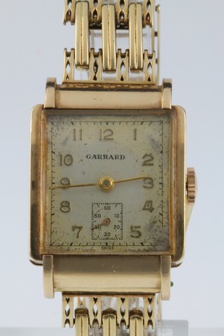 A gentleman's 1930's 9ct gold Garrard wristwatch with seconds at 6 o'clock on an open gate bracelet 38 grams 