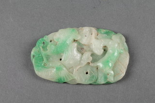 A carved apple green jadeite pendant with stylised animals and fish 4" 