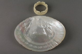 A carved mother of pearl shell and a bone napkin ring 