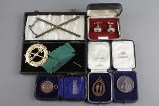 A cased bronze rifle medallion and minor medallions