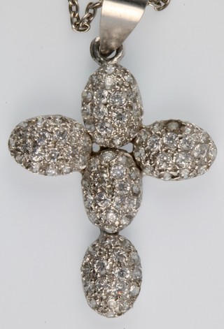 An 18ct white gold diamond set cross on chain