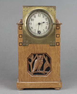 An Art Nouveau timepiece with silvered dial and Arabic numerals contained in an oak case