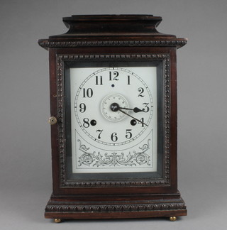 "John Bull" an alarm clock with enamelled dial, Roman numerals and alarm dial contained in a walnut case 