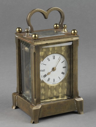 A miniature carriage clock with 1" circular enamelled dial and Roman numerals, contained in a gilt metal case 3"h x 2"w x 1 1/2"d 