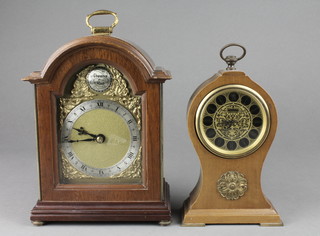 A Fema Georgian style bracket clock with arched gilt dial, silvered chapter ring contained in a mahogany case, together with Europa Regency style alarm clock contained in a mahogany balloon case 