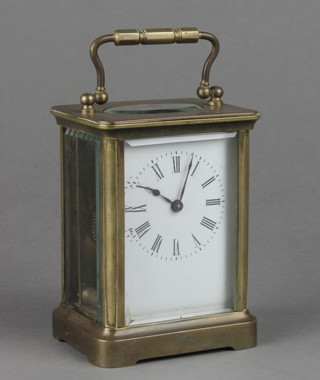 A 19th Century French 8 day carriage clock with enamelled dial and Roman numerals, contained in a gilt metal case 4"h x 3"w x 2 1/2"d
