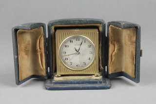 Zenith, a Swiss Art Deco travelling alarm clock with circular silvered dial and Arabic numerals contained in a gilt metal case 2 1/2" x 2" x 1" 