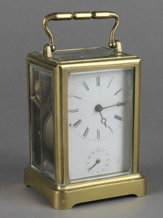 A 19th Century French 8 day carriage alarm clock with enamelled dial and Roman numerals, contained in a gilt metal case 