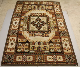 A Spanish machine made white and brown ground carpet with central medallion 115" x 79"