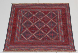 A Tribal Gazak red ground square rug with numerous diamonds to the centre 50 1/2" x 50 1/2"  