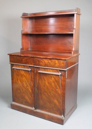 A William IV mahogany chiffonier with raised back and shelf, the base fitted 2 dome fronted drawers above a double cupboard, enclosed by a pair of panelled doors 50 1/2"h x 31 1/2" w x 17 1/2" d