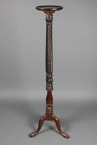 A 19th Century turned mahogany torchere raised on pillar and tripod supports and ending in ball and claw feet 51"h x 9" d