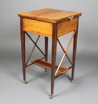An Edwardian inlaid mahogany square work table with cross banded sliding top, with undertier and X framed stretcher, raised on square tapered supports ending in brass cappings and castors 28" h x 16" w x 16" d
