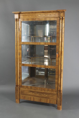 A Dutch style inlaid mahogany corner cabinet with mirrored interior, having columns to the side enclosed by bevelled plate panelled door 65 1/2"h x 37"w x 21"d 