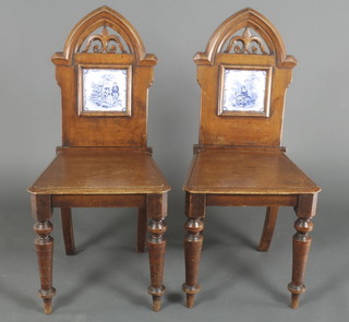 A pair of Victorian mahogany style hall chairs with arched pierced backs inset blue & white tiles with solid seats rasied on turned supports 36" h x 14"w x 17"d
