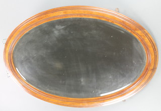 An oval bevelled plate mirror contained in a mahogany frame 36"w x 25"h