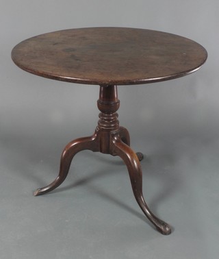 A Georgian mahogany snap top tea table raised on turned column and tripod supports 28"h x 33"d