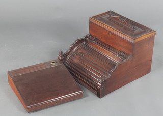A Victorian mahogany stationery box with raised back and hinged lid, fitted compartments, the tambour shutter to the front revealing a writing slope complete with inkwell 10"h x 14"w x 15"d 