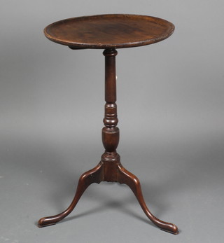 A 19th Century circular mahogany dish top wine table raised on turned tripod base 27"h x 16 1/2" diam.