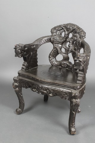 A Chinese ebonised pierced carved wood throne chair with dragon arms, raised on cabriole supports