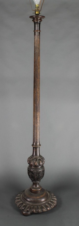 A turned and reeded mahogany standard lamp raised on a circular carved 60" 
