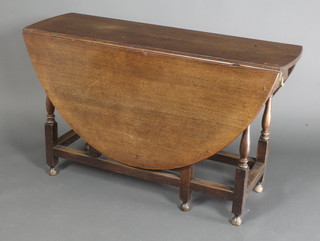 An 18th/19th Century oak oval drop flap gateleg dining table, fitted 2 frieze drawers, raised on turned supports 28"h x 48"w x 15" when closed x 57" when fully extended